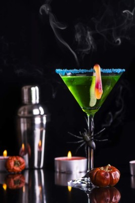 Green halloween cocktail witch's brew. Selective focus