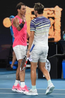 Spain's Rafael Nadal (L) congratulates Austria's Dominic Thiem on his victory in their men's singles quarter-final match on day ten of the Australian Open tennis tournament in Melbourne on January 30, 2020. (Photo by William WEST / AFP) / IMAGE RESTRICTED TO EDITORIAL USE - STRICTLY NO COMMERCIAL USE