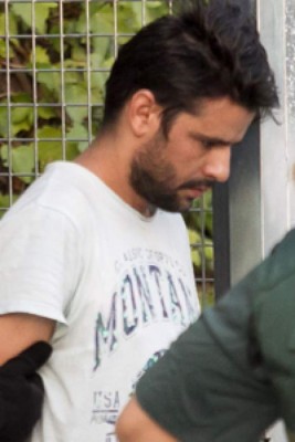 Mohamed Aallaa, suspected of involvement in the terror cell that carried out twin attacks in Spain, is escorded by Spanish Civil Guards from a detention center in Tres Cantos, near Madrid, on August 22, 2017 before being tranferred to the National Court.Under heavy security, police vans entered the National Court, which deals with terrorism cases, where a judge will question them and decide what -- if any -- charges to press against them over the vehicle attacks that left 15 dead and 120 injured. / AFP PHOTO / STRINGER