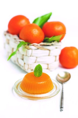 jelly and fresh orange mandarins with leafs in crib