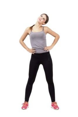 Young fit woman warming up and stretching neck looking up. Full body length portrait isolated over white background.