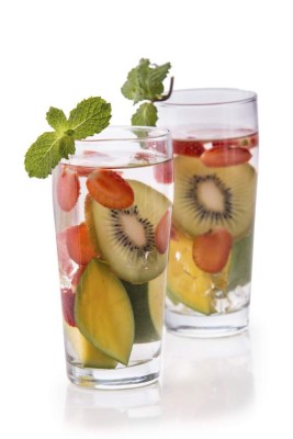 Summer fresh fruit Flavored infused water mix of kiwi, mango and strawberry isolated over white background