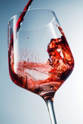 Red wine pouring in glass