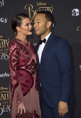 Model Chrissy Teigen (L) and recording artist John Legend attend the world premiere of Disney's Beauty and the Beast at El Capitan Theatre in Hollywood, California on March 2, 2017. / AFP PHOTO / VALERIE MACON