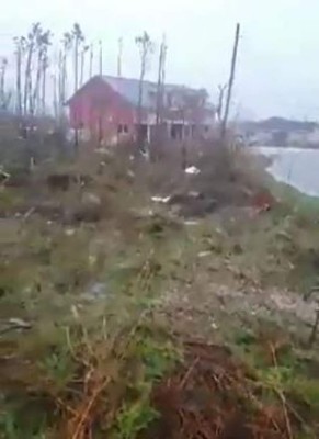 Destroyed trees are seen near houses in Central Pines in Marsh Harbour on Abaco Island in the Bahamas on September 2, 2019 - Monster storm Dorian came to a near stand-still over the Bahamas, prolonging the agony as surging seawaters and hurricane winds made a shambles of low-lying island communities and spurred mass evacuations along the US east coast. (Photo by Ramond A King / FACEBOOK / AFP) / RESTRICTED TO EDITORIAL USE - MANDATORY CREDIT 'AFP PHOTO / FACEBOOK / Ramond A. King' - NO MARKETING NO ADVERTISING CAMPAIGNS - DISTRIBUTED AS A SERVICE TO CLIENTS