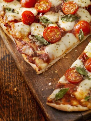 Margherita Pizza with Fresh Mozzarella,Tomatoes and Basil on Thin Flat Bread - Photographed on a Hasselblad H3D11-39 megapixel Camera System