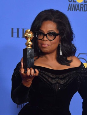 TOPSHOT - Actress and TV talk show host Oprah Winfrey poses with the Cecil B. DeMille Award during the 75th Golden Globe Awards on January 7, 2018, in Beverly Hills, California. / AFP PHOTO / Frederic J. BROWN