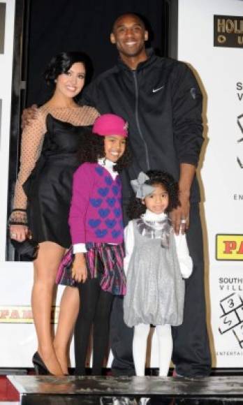 (FILES) In this file photo taken on February 19, 2011 Legendary Los Angeles Lakers shooting guard Kobe Bryant attends with his wife Vanessa and daughters Natalia Diamante and Gianna Maria-Onore (R), his hand and footprint ceremony at the Graumans Chinese Theater in Hollywood, California. - NBA legend Kobe Bryant died Sunday in a helicopter crash in suburban Los Angeles, celebrity website TMZ reported, saying five people are confirmed dead in the incident. (Photo by Gabriel BOUYS / AFP)