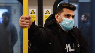 TOPSHOT - A woman sits outside the Santiago de Compostela Cathedral in the usually overcrowded Obradoiro Square in Santiago de Compostela on March 14, 2020 after regional authorities ordered all shops in the region be shuttered from today through March 26, save for those selling food, chemists and petrol stations, in order to slow the coronavirus spread. (Photo by MIGUEL RIOPA / AFP)