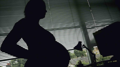 A pregnant woman from El Salvador seeking asylum touches her stomach at a Catholic Charities relief center on Sunday, June 17, 2018 in McAllen, Texas. - People went to the center for assistance after being released from detention through 'catch and release' immigration policy. (Photo by Loren ELLIOTT / AFP) (Photo credit should read LOREN ELLIOTT/AFP/Getty Images)