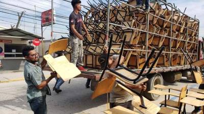 Los pupitres son descargados para ser entregados en un centro educativo de Choloma.