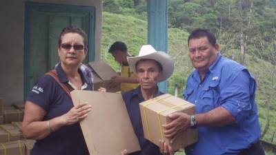 El alcalde Ricardo Alvarado -derecha- entrega los páneles a los pobladores.