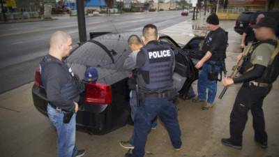 SLUG: ME/FUGITIVE (aka RAID), #3 DATE: 04/11/2007 PHOTOGRAPHER: Sarah L. Voisin Arlington, Va NEG #: 189770 Accompaning Immigrations and Customs Enforcement (ICE) on a raid of several homes in various parts of Northern Virginia to arrest specific illegal immigrants. A total of 6 were arrested. PICTURED: Jose Artica, 19, of El Salvador, is handcuffed and removed from a house in Alexandria, VA shortly after 4am. He was the only person taken into detention this night that was not on the fugitive operation team's list. He was renting a room from his cousin who was on the list and the ICE agents take additional people at the address who do not have legal papers. (Photo by Sarah L. Voisin/The Washington Post/Getty Images)