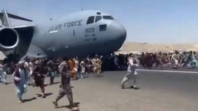 Cientos de afganos siguieron un avión de EEUU en la pista del aeropuerto de Kabul tras la llegada de los talibanes a la capital./AFP.