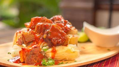 Un platillo de origen criollo, donde varía la preparación del cerdo y la ensalada oencurtido.