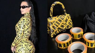 El ceñido atuendo amarillo con cinta de precaución de Kim envolvía todo su cuerpo, incluidos sus tacones de aguja puntiagudos y su bolso Balenciaga.