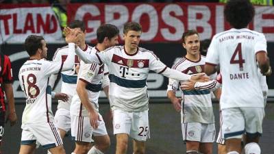 El delantero internacional del Bayern Múnich, Thomas Müller, celebra junto a sus compañeros uno de los tres goles ante el Eintracht Fráncfort.