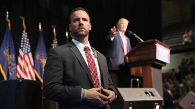 US President Donald Trump is being removed by a member of the secret service from the Brady Briefing Room of the White House in Washington, DC, on August 10, 2020. (Photo by Brendan Smialowski / AFP)