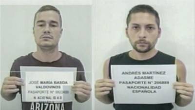 Los ciudadanos españoles José María Basoa(i) y Andrés Martínez Adasne (d) sosteniendo una hoja con sus datos de identificación, tras ser detenidos en Venezuela.