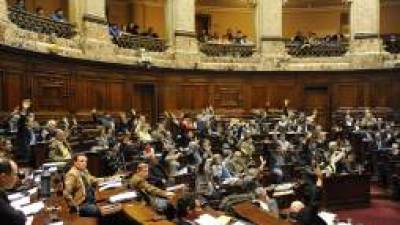 Uruguayan lawmakers vote the bill legalizing marijuana, in Montevideo, on July 31, 2013. Uruguay's lower house voted --50 out of 96-- the controversial bill which for the first time would put a government in charge of production and distribution of legal marijuana. The bill, unveiled in June 2012 as part of a series of measures to combat rising violence, will now head to the Senate for final passage. AFP PHOTO/MIGUEL ROJO