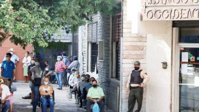 Personas hacen filas en bancos hoy en Tegucigalpa (Honduras). EFE