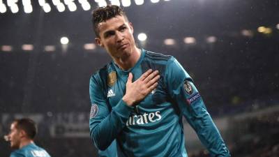 Juventus' Portuguese striker Cristiano Ronaldo puts on his shirt as he prepares to come onto the field during the Italian Serie A football match between Spezia and Juventus at The Dino Manuzzi Stadium in Cesena on November 1, 2020. (Photo by VINCENZO PINTO / AFP)