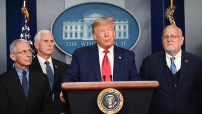 US President Donald Trump speaks as Director of the National Institute of Allergy and Infectious Diseases at the National Institutes of Health Anthony Fauci (L), US Vice President Mike Pence (2L), and  Director of the Centers for Disease Control and Prevention Robert Redfield (R) look on during a press conference on the COVID-19, coronavirus, outbreak at the White House in Washington, DC on February 29, 2020. - The number of novel coronavirus cases in the world rose to 85,919, including 2,941 deaths, across 61 countries and territories by 1700 GMT on Saturday, according to a report gathered by AFP from official sources. (Photo by Roberto SCHMIDT / AFP)