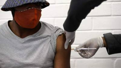 A man shows a vial of the US Johnson and Johnson vaccine against the Covid-19 coronavirus donated by the United States, at the Sukraraj tropical hospital vaccine storage cold room in Kathmandu on July 12, 2021. (Photo by PRAKASH MATHEMA / AFP)