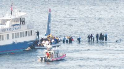 Passengers in an inflatable raft prepare to move away from an Airbus 320 US Airways aircraft that has gone down in the Hudson River in New York, Thursday Jan. 15, 2009. It was not immediately clear if there were injuries. (AP Photo/Bebeto Matthews)