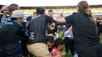 Los seguidores de Atlas peleando con los seguidores de Querétaro durante el partido de fútbol del torneo clausura mexicano.