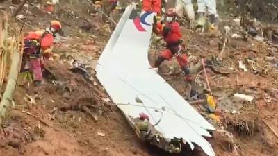 Equipos de rescate con una pieza del fuselaje mientras continúan su búsqueda en el lugar donde el avión de pasajeros de China Eastern se estrelló contra la ladera de una montaña cerca de Ciudad de Wuzhou.
