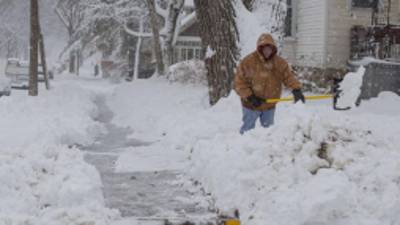 BARABOO, WI -DECEMBER 20: Lisa Schultz shovels her sidewalk during a winter storm December 20, 2012 in Baraboo, Wisconsin. The State Patrol had warned motorists to stay home as a paralyzing winter storm bore down on Wisconsin, the first significant snowstorm to hit southern Wisconsin in two winters. Tom Lynn/Getty Images/AFP== FOR NEWSPAPERS, INTERNET, TELCOS & TELEVISION USE ONLY ==