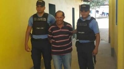 Detenido es custodiado por dos agentes de la Policía Nacional de Honduras.