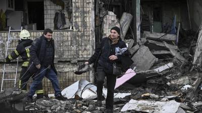 Un hombre recupera objetos de un bloque de apartamentos destruido tras un bombardeo en Kiev.