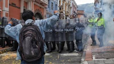 La Policía antidisturbios bloquea una calle durante los enfrentamientos que siguieron a una marcha de miembros de organizaciones civiles y sociales y estudiantes.