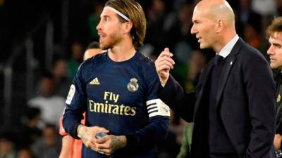 El entrenador del Real Madrid Zinedine Zidane (d) habla con el capitán Sergio Ramos.