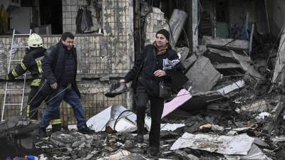 Un hombre recupera objetos de un bloque de apartamentos destruido tras un bombardeo en Kiev.