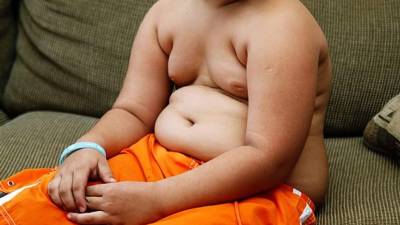Adorable child playing the basketball in the basket field
