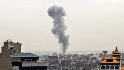 Smoke billows above buildings in Rafah in the southern Gaza Strip during an Israeli airstrike on the Palestinian coastal enclave, on May 5, 2019. - Israeli Prime Minister Benjamin Netanyahu vowed today to continue 'massive strikes' in response to rocket fire from the Gaza Strip as a deadly escalation entered a second day, sparking fears of wider violence. (Photo by Said KHATIB / AFP)
