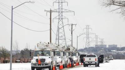 FORT WORTH, TX - FEBRUARY 16: Pike Electric service trucks line up after a snow storm on February 16, 2021 in Fort Worth, Texas. Winter storm Uri has brought historic cold weather and power outages to Texas as storms have swept across 26 states with a mix of freezing temperatures and precipitation. Ron Jenkins/Getty Images/AFP== FOR NEWSPAPERS, INTERNET, TELCOS & TELEVISION USE ONLY ==