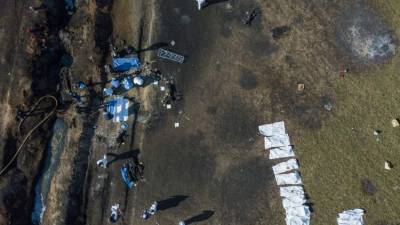 EDITORS NOTE: Graphic content / Aerial view of the scene where a massive blaze trigerred by a leaky pipeline took place the night before in Tlahuelilpan, Hidalgo state, Mexico on January 19, 2019. - An explosion and fire has killed at least 66 people who were collecting fuel gushing from a leaking pipeline in central Mexico, the Hidalgo state governor said on Saturday. (Photo by ALFREDO ESTRELLA / AFP)