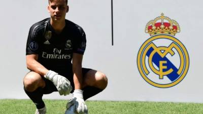 Real Madrid's new Ukrainian goalkeeper Andriy Lunin poses on the pitch during his official presentation at the Santiago Bernabeu Stadium in Madrid on July 23, 2018. / AFP PHOTO / JAVIER SORIANO