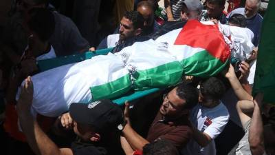 Hombres palestinos cargan el cuerpo de Saad Dawabsha, el padre de bebé palestino quemado vivo por extremistas judíos.