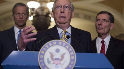 US Senate Majority Leader Mitch McConnell (C), Republican of Kentucky, speaks about the Senate Republican's healthcare bill alongside US Senator John Thune (L), Republican of South Dakota, and US Senator John Barrasso (R), Republican of Wyoming, at the US Capitol in Washington, DC, June 27, 2017.Republicans eager to repeal 'Obamacare' suffered a deeply embarrassing setback Tuesday when shrinking support forced them to postpone votes on their controversial health care overhaul, one of President Donald Trump's top priorities. / AFP PHOTO / SAUL LOEB