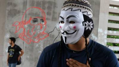 Integrantes del Movimiento Estudiantil Universitario (MEU) en una protesta en Tegucigalpa, capital de Honduras. / AFP PHOTO / Orlando SIERRA