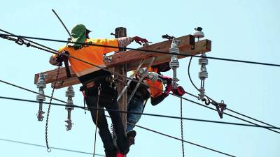 Empleados de la EEH dan mantenimiento a líneas de transmisión en San Pedro Sula.