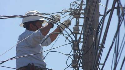 Empleado de la Enee realiza trabajos de mantenimiento.