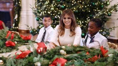 La exmodelo eslovena recorrió cada una de las salas decoradas y deseó una feliz Navidad en nombre de su esposo y el hijo de ambos, Barron.EFE/OLIVIER DOULIERY / POOL