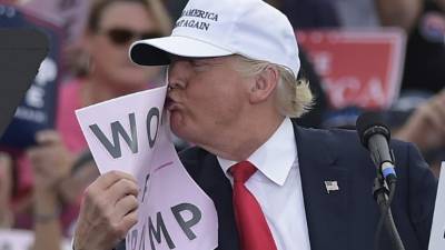 El republicano Donald Trump besa una papel con el mensaje “Women for Trump”. Foto: AFP/Mandel Ngan
