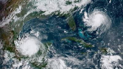 This National Oceanic and Atmospheric Administration(NOAA) satellite handout image shows Hurricane Grace (lower L) and Tropical Storm Henri (upper R) at 13:30UTC, on August 20, 2021. - Grace moved westwards in the Gulf of Mexico, regaining hurricane strength ahead of an expected second landfall August 20, after tearing through the Yucatan Peninsula. The US National Hurricane Center issued a hurricane watch for Henri as the system heads toward New England, and is on track to impact the region as a hurricane by August 22. (Photo by Handout / NOAA/GOES / AFP) / RESTRICTED TO EDITORIAL USE - MANDATORY CREDIT 'AFP PHOTO / NOAA/GOES' - NO MARKETING - NO ADVERTISING CAMPAIGNS - DISTRIBUTED AS A SERVICE TO CLIENTS